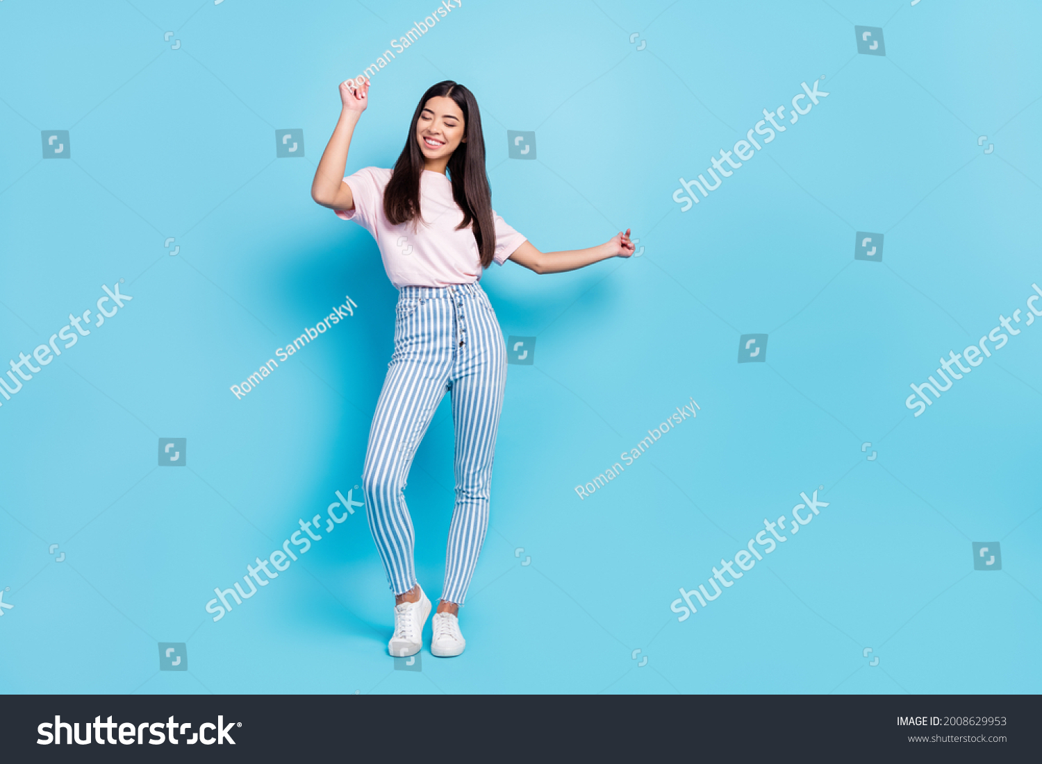 Full length body size view of attractive cheerful slender carefree girl dancing moving isolated over bright blue color background Stock-foto