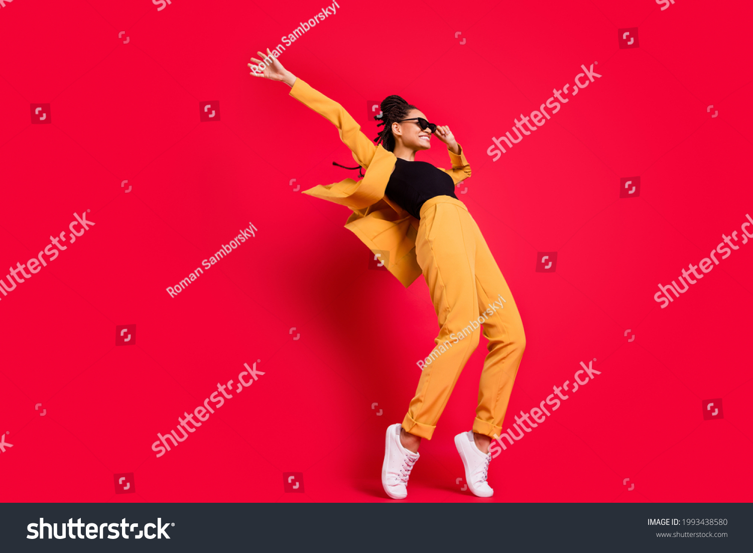 Full size profile photo of funny lady dance wear eyewear yellow suit isolated on vivid red color background Stock-foto